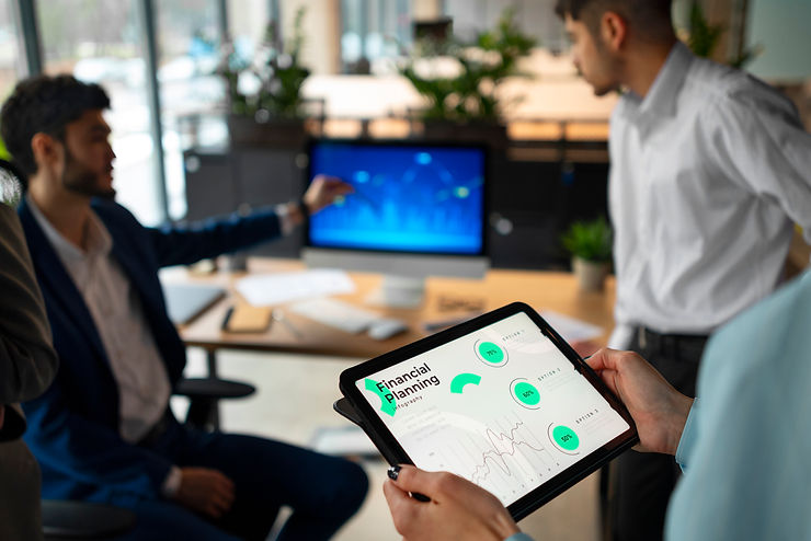 Three colleagues engaging in a graph on a computer screen